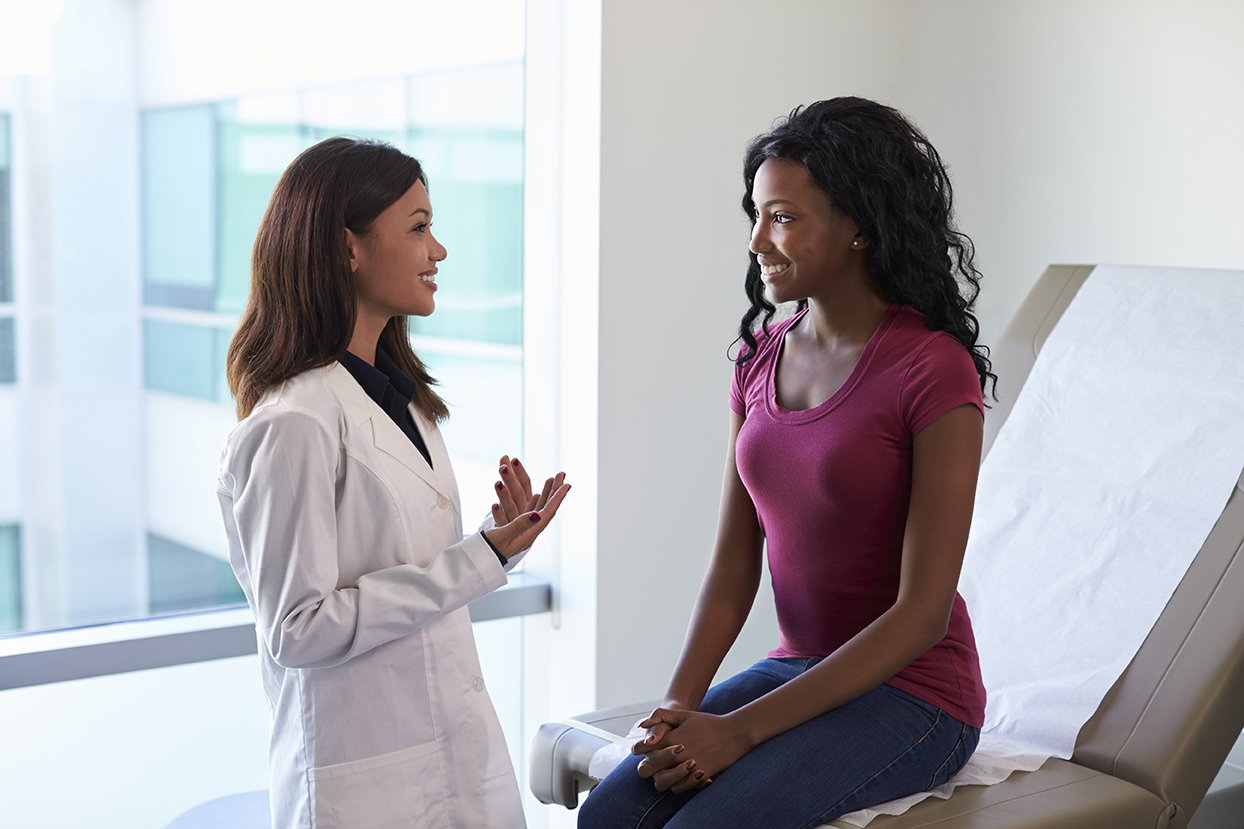 Female Doctor Meeting With Patient In Exam Room